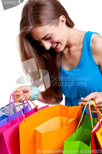 Image of attractive young woman with colorful shopping bags isolated