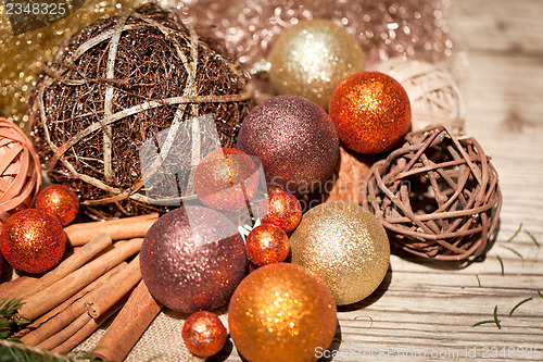 Image of glittering christmas decoration in orange and brown natural wood 