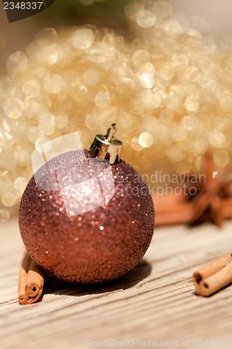 Image of anice cinnamon and bauble christmas decoration in gold