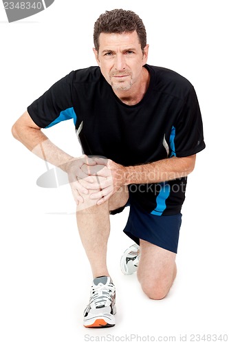 Image of adult attractive man in sportswear knee pain injury ache isolated