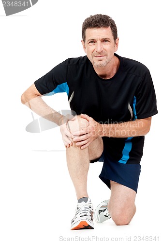 Image of adult attractive man in sportswear knee pain injury ache isolated