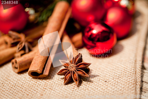 Image of christmas decoration cinnamon anise baubles in red 