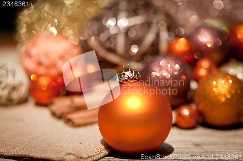 Image of glittering christmas decoration in orange and brown natural wood 