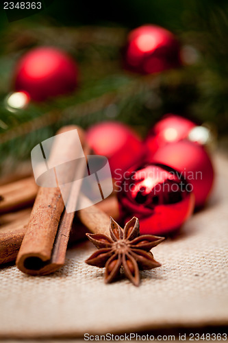 Image of christmas decoration cinnamon anise baubles in red 