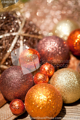 Image of glittering christmas decoration in orange and brown natural wood 