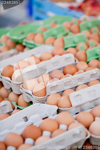 Image of group of eggs in carton box closeup market outdoor