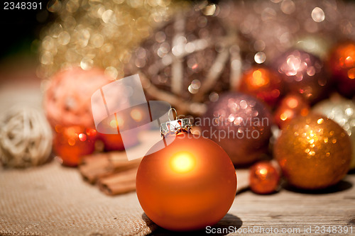 Image of glittering christmas decoration in orange and brown natural wood 