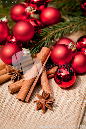 Image of christmas decoration cinnamon anise baubles in red 