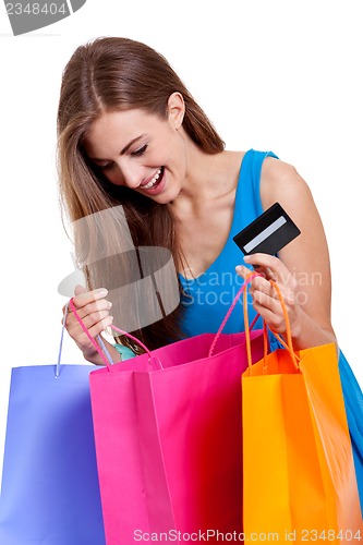 Image of happy young woman with colorful shopping bags visa isolated