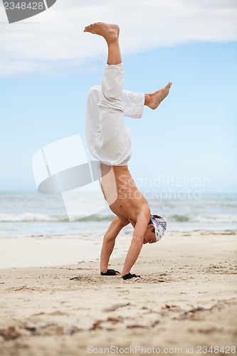 Image of man is jumping sport karate martial arts fight kick