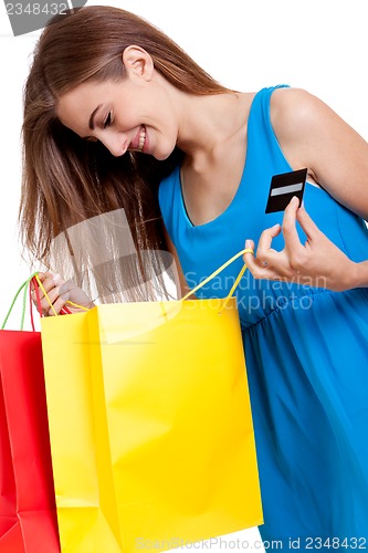 Image of happy young woman with colorful shopping bags visa isolated