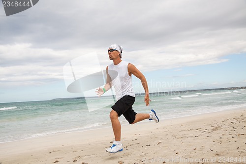 Image of man is jogging on the beach summertime sport fitness