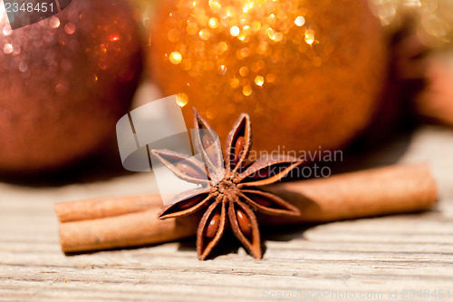 Image of anice cinnamon and bauble christmas decoration in gold