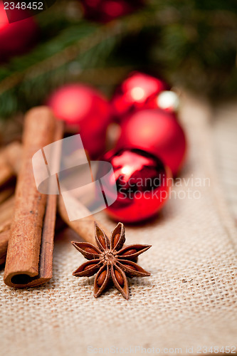 Image of christmas decoration cinnamon anise baubles in red 