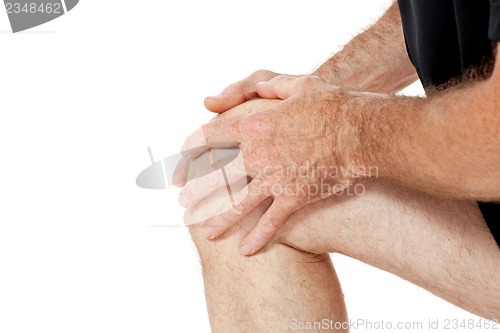 Image of adult attractive man in sportswear knee pain injury ache isolated