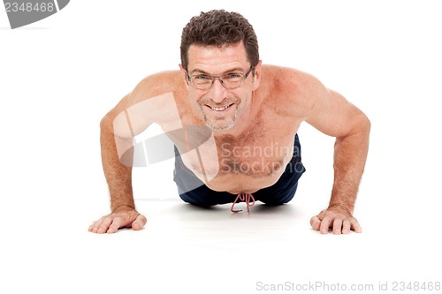 Image of adult smiling man doing workout pushups isolated