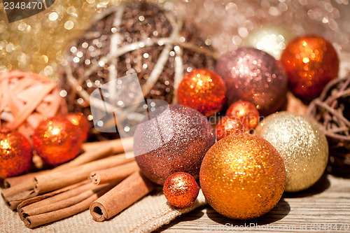 Image of glittering christmas decoration in orange and brown natural wood 