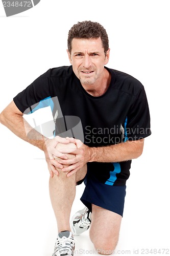 Image of adult attractive man in sportswear knee pain injury ache isolated