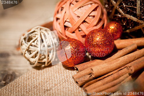 Image of glittering christmas decoration in orange and brown natural wood 