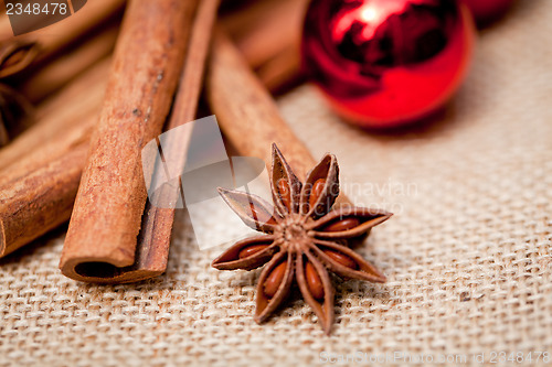 Image of christmas decoration cinnamon anise baubles in red 