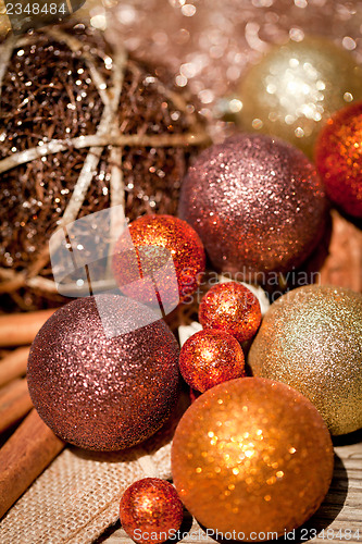 Image of glittering christmas decoration in orange and brown natural wood 