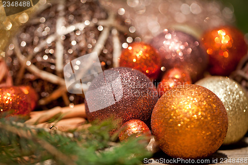 Image of glittering christmas decoration in orange and brown natural wood 