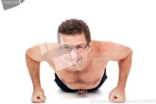 Image of adult smiling man doing workout pushups isolated