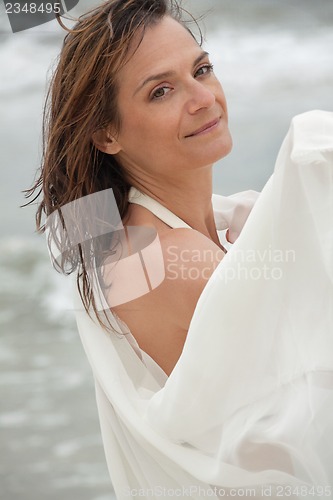 Image of attractive smiling adult woman outside in summer