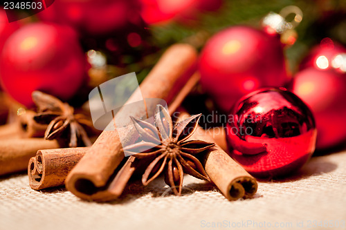 Image of christmas decoration cinnamon anise baubles in red 