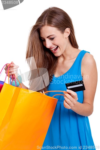 Image of happy young woman with colorful shopping bags visa isolated