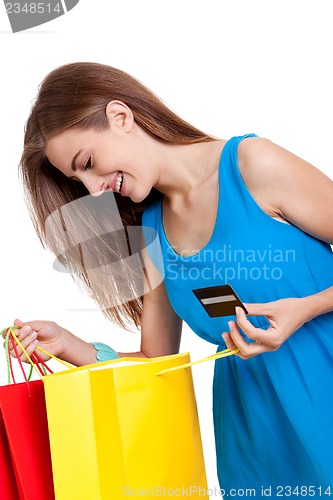 Image of happy young woman with colorful shopping bags visa isolated