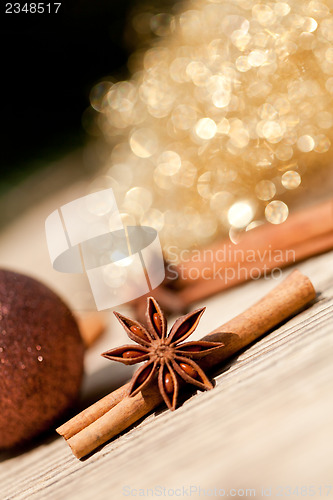 Image of anice cinnamon and bauble christmas decoration in gold