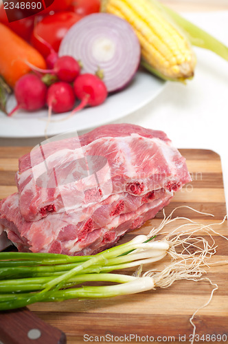 Image of chopping fresh pork ribs and vegetables