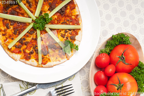 Image of Turkish beef pizza with cucumber on top