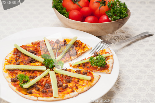 Image of Turkish beef pizza with cucumber on top