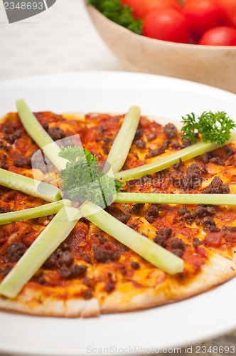 Image of Turkish beef pizza with cucumber on top