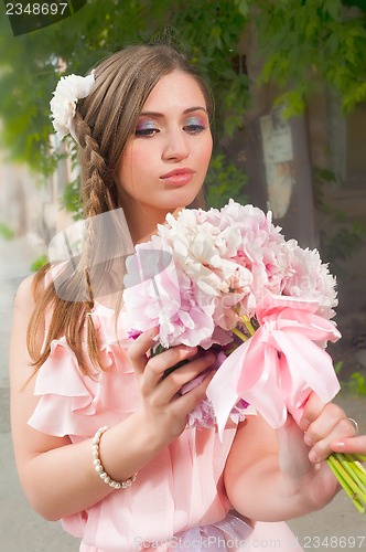 Image of beautiful woman with flower...