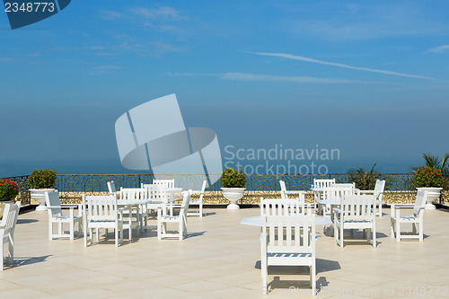 Image of An empty rooftop restaurant with views of the sea