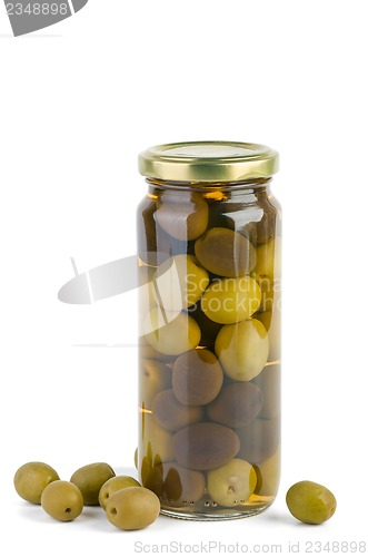 Image of Glass jar with green and black olives . Some near