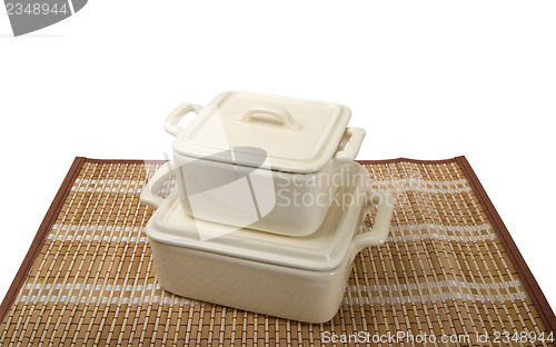 Image of Two ceramic pots for stove on bamboo mat
