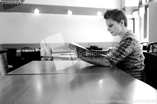 Image of Young happy woman in a restaurant