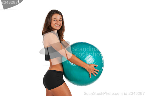 Image of Young woman in the studio with fitness ball