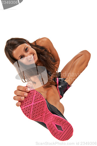 Image of Young woman in the studio streching and working out