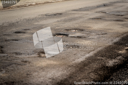 Image of Damaged car road with a lot of cracks