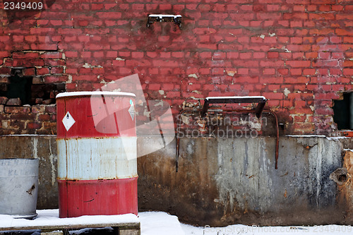 Image of Red brick wall with barrel