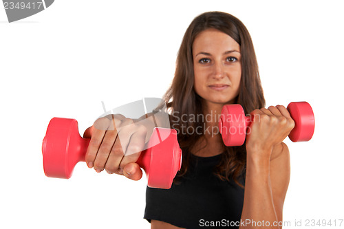 Image of Young woman in the studio with weights