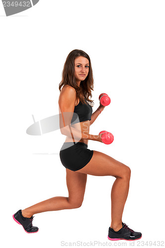 Image of Young woman in the studio with weights working out