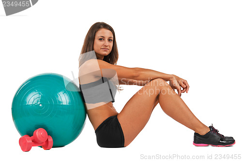 Image of Young woman with sport gymnastic ball