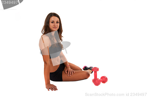 Image of Young woman in the studio with weights