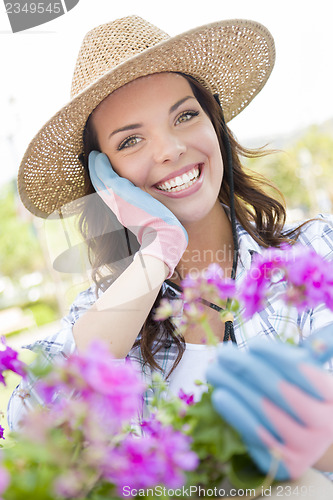 Image of Young Adult Woman Wearing Hat Gardening Outdoors